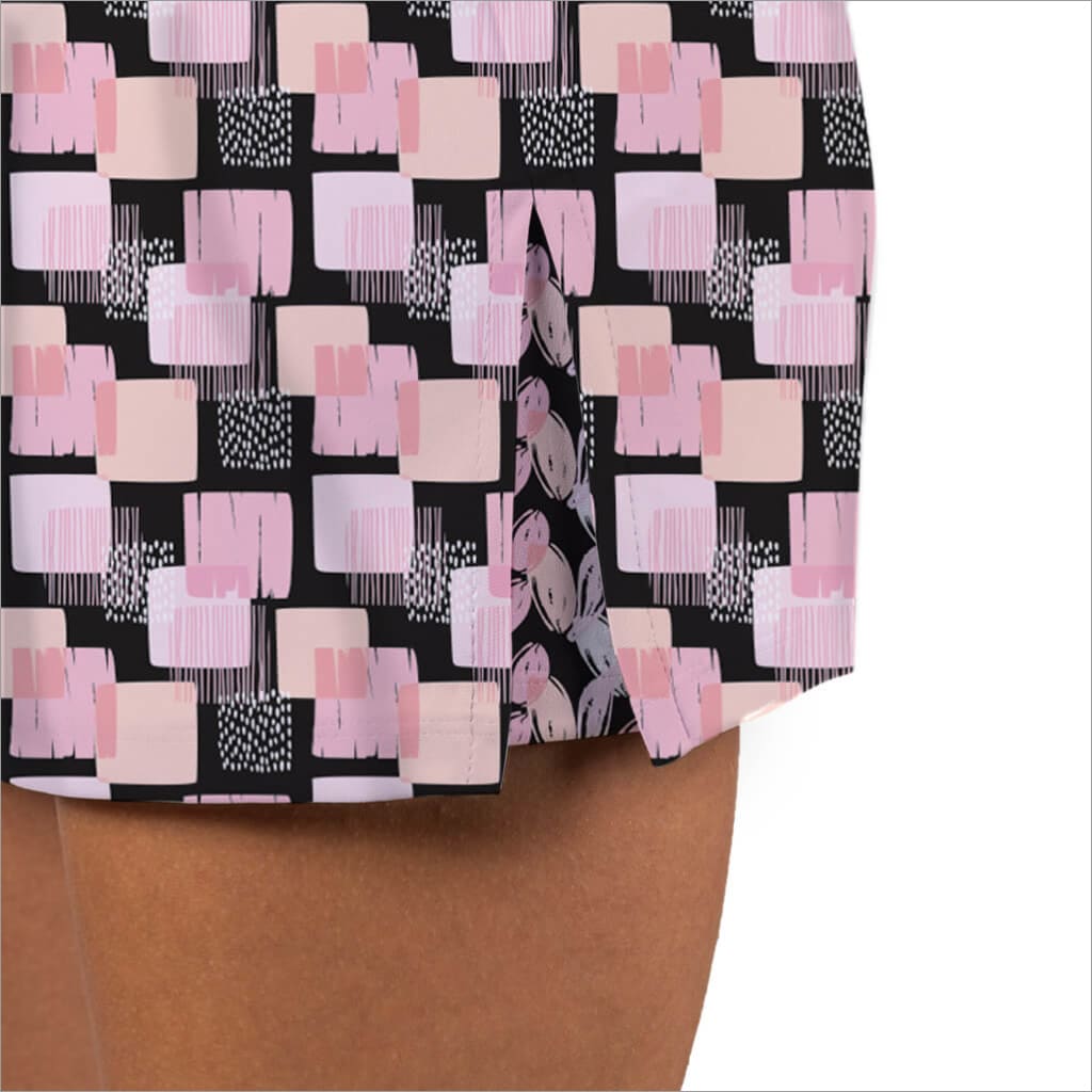 Abstract patterned fabric with pink and beige shapes on a black background