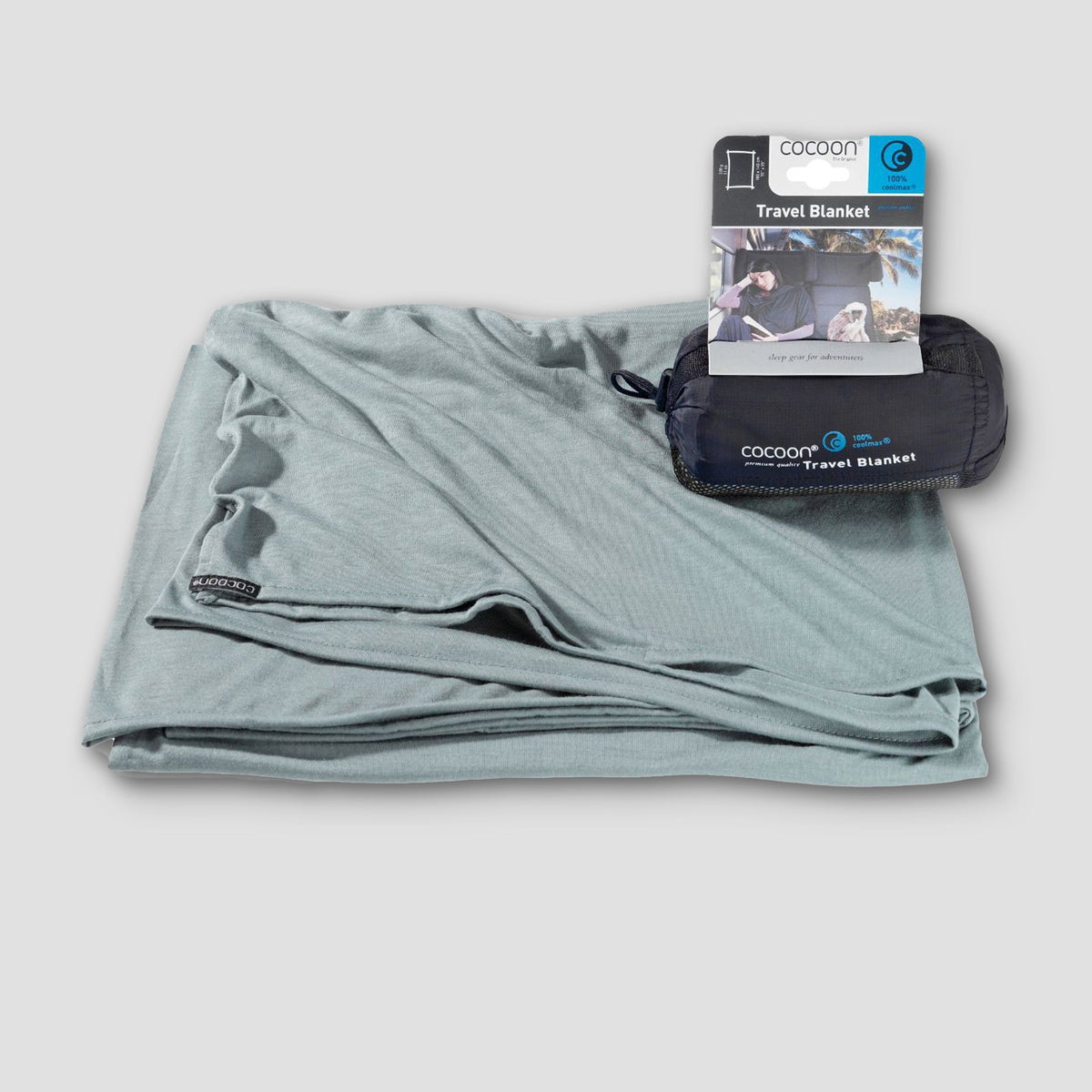Gray travel blanket with packaging on a light gray background