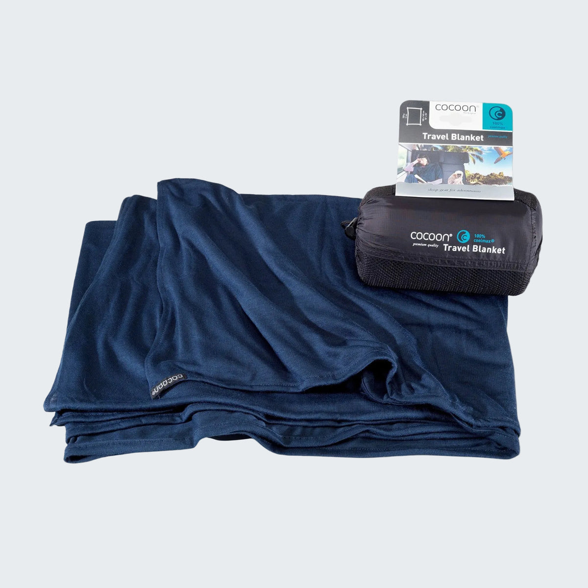 Blue travel blanket with packaging on a light gray background
