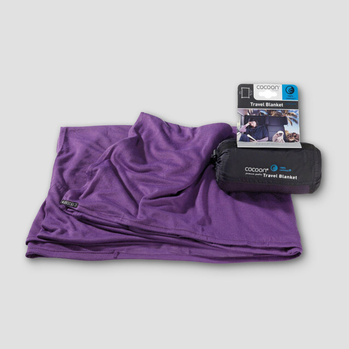 Purple travel blanket with packaging on a light gray background