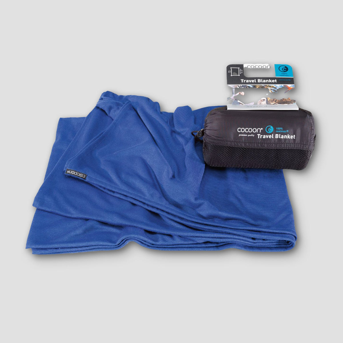 Blue travel blanket with packaging on a light gray background