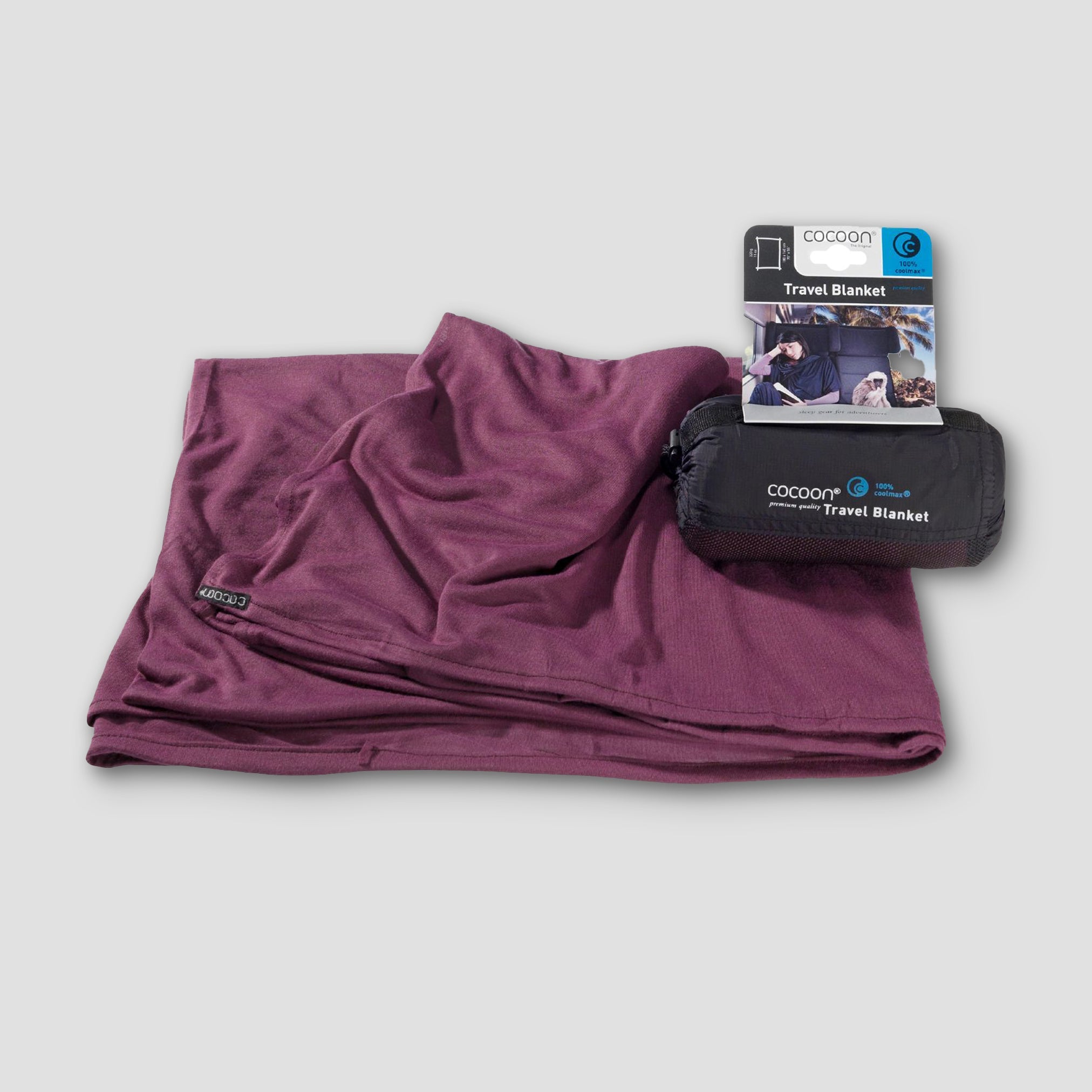 Purple travel blanket with packaging on a light gray background