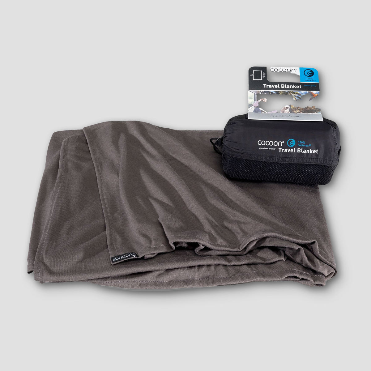 Gray travel blanket with packaging on a light gray background