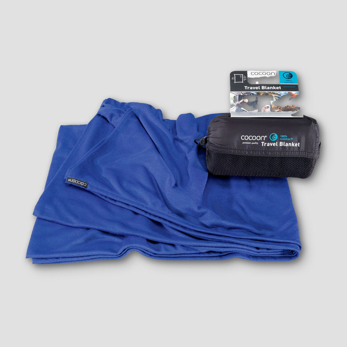Blue travel blanket with packaging on a gray background