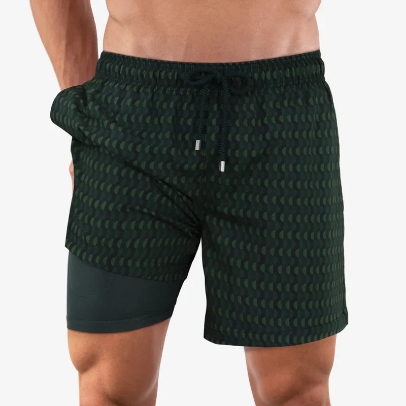 Green patterned shorts worn by a person on a white background