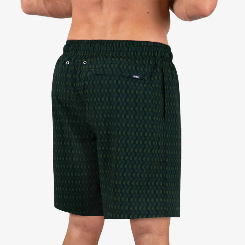 Green patterned shorts worn by a person on a white background