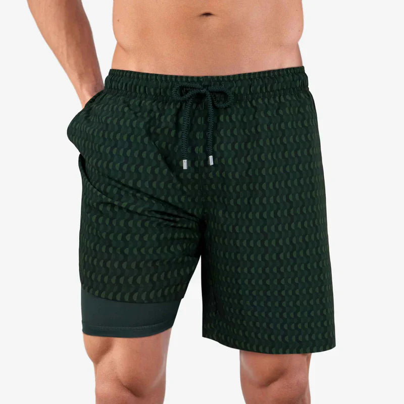 Green patterned shorts worn by a person on a white background