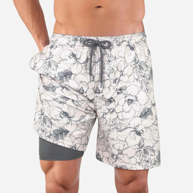Floral patterned shorts worn by a person on a white background