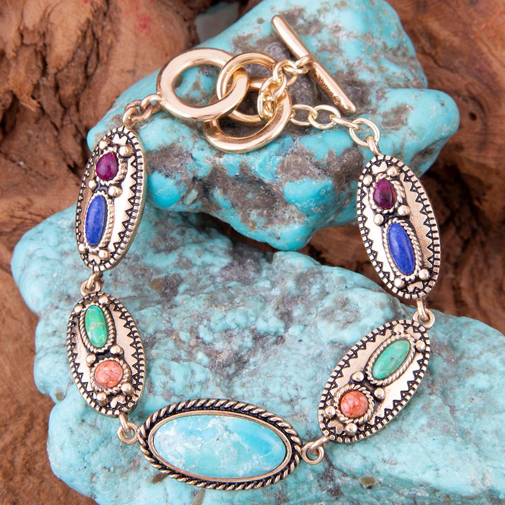 Bracelet with colorful stones on a turquoise stone background