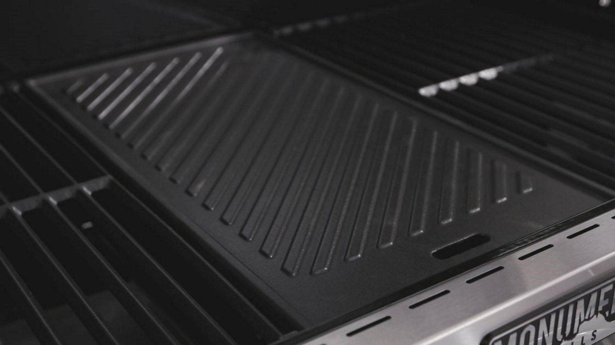 Close-up of a black grill pan with visible branding on a dark background