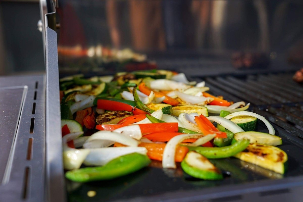 Vegetables being grilled on a barbecue with a blurred background
