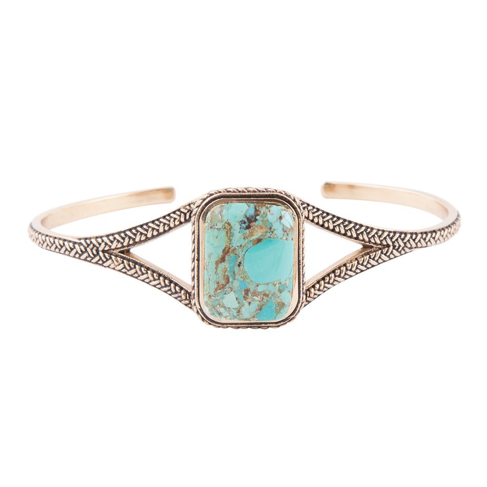 Turquoise stone bracelet with gold-toned metalwork on a white background