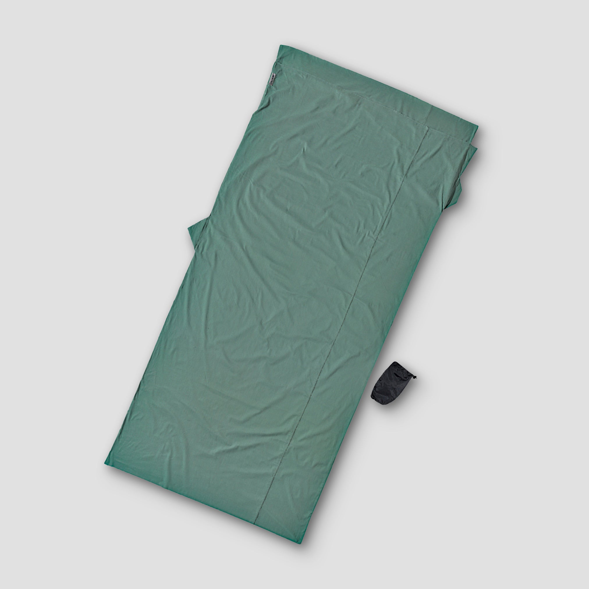Green sleeping pad on a light gray background