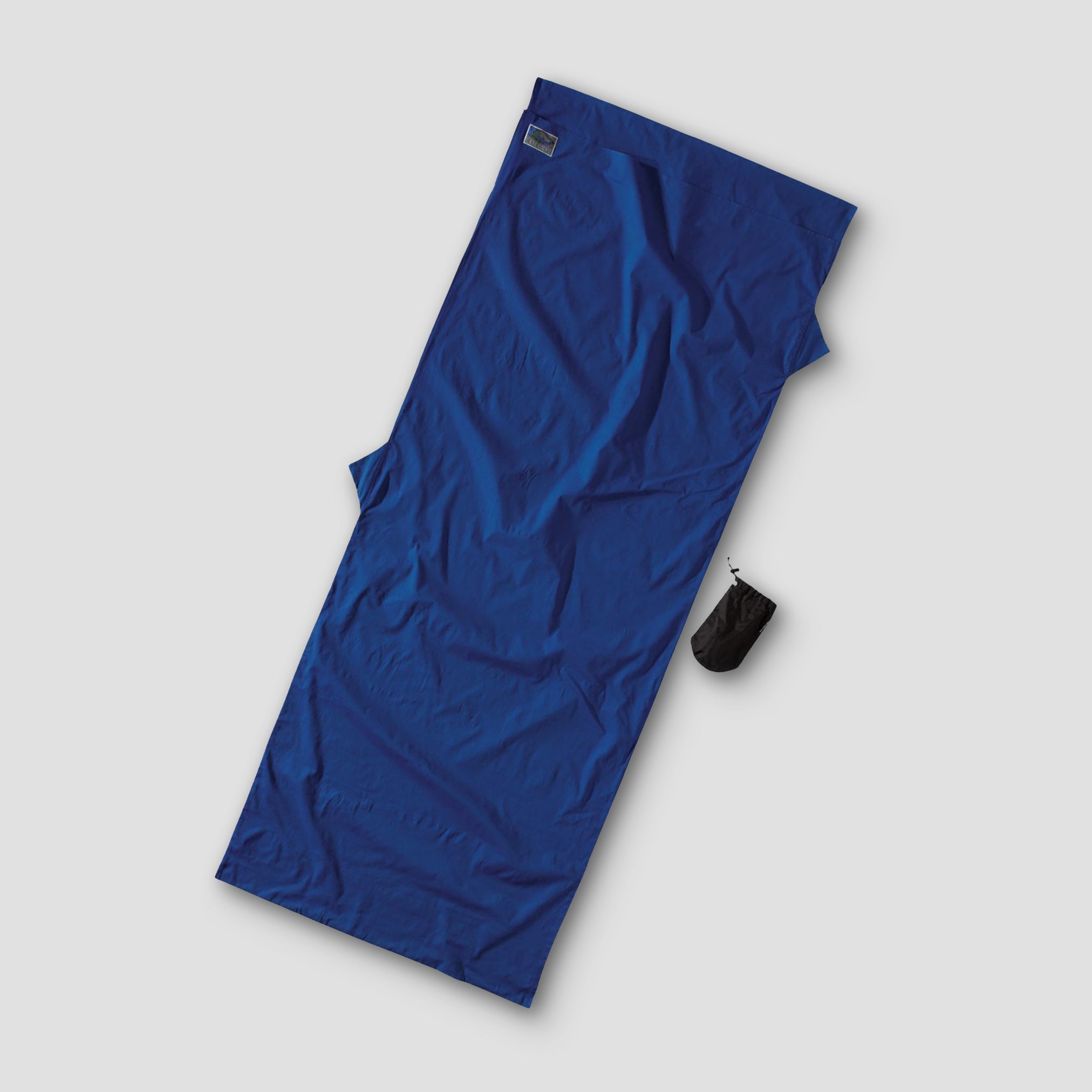 Blue sleeping bag on a light gray background
