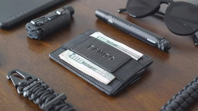 Black wallet with cards on a wooden surface with tools and accessories.