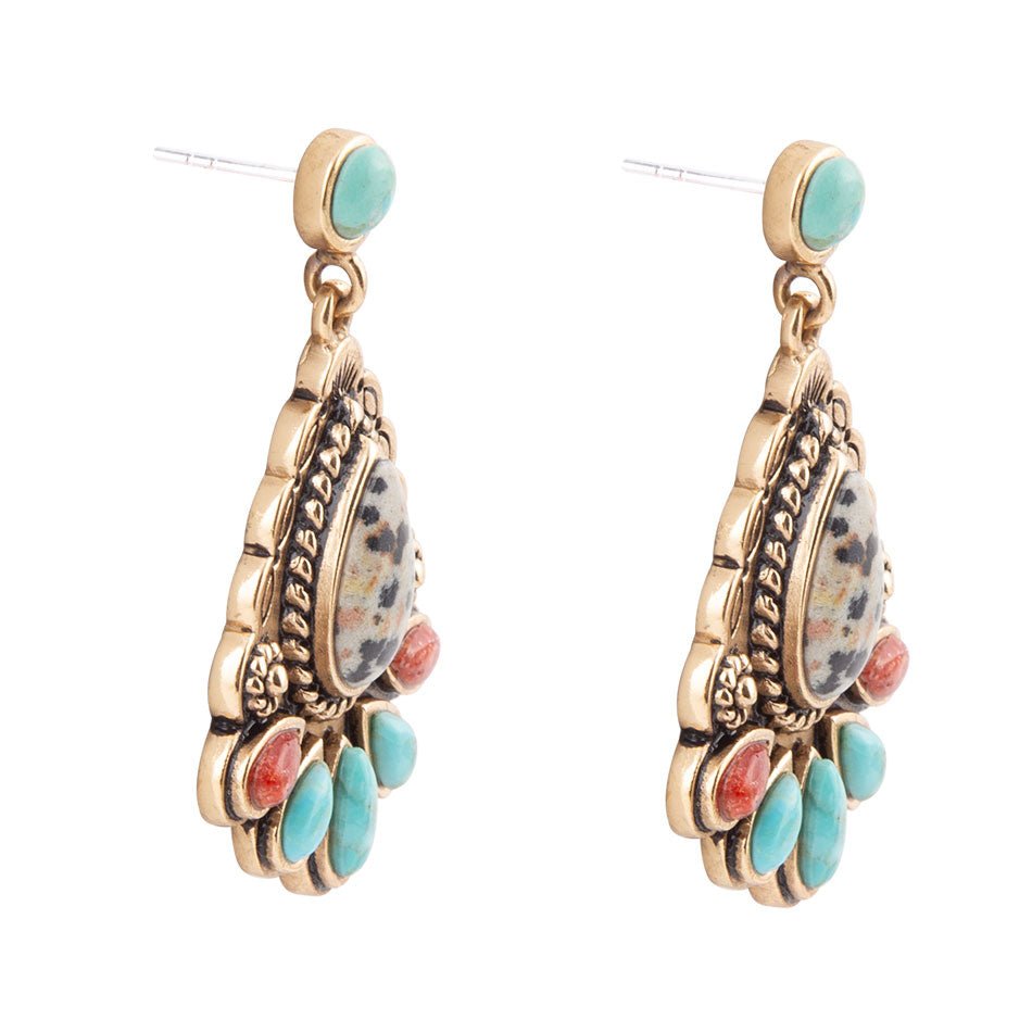 Pair of ornate earrings with turquoise and coral accents on a white background