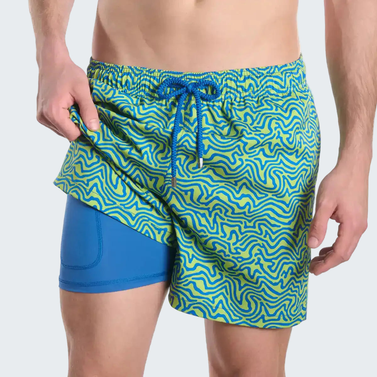 Blue and green patterned swim shorts on a white background