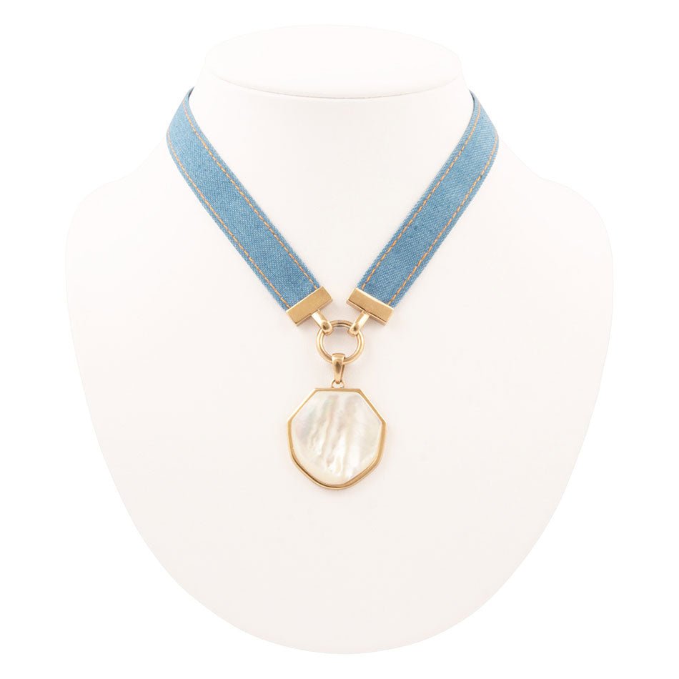 Necklace with blue ribbon and gold clasp on a white background