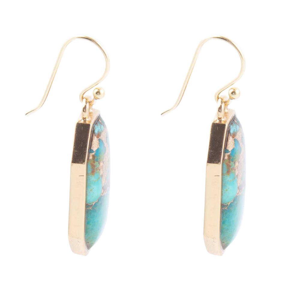 Gold and turquoise earrings on a white background
