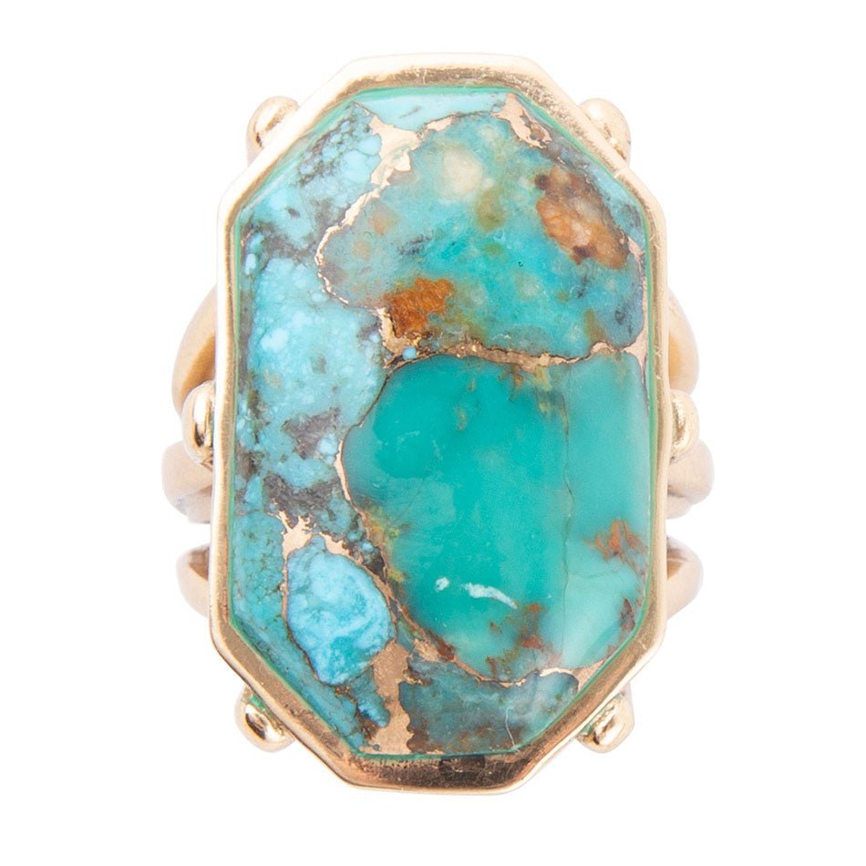 Turquoise ring with gold accents on a white background