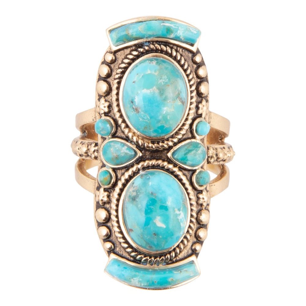 Turquoise stone ring with gold accents on a white background