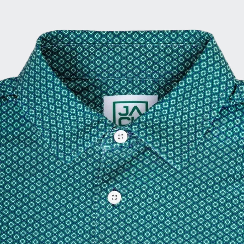 Close-up of a teal green patterned button-down shirt collar with white buttons and a visible J.A. Pincay label.