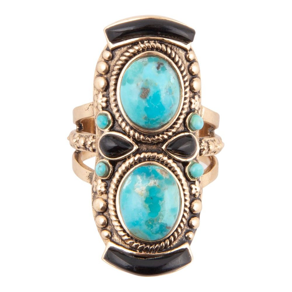 Gold and black ring with turquoise stones on a white background