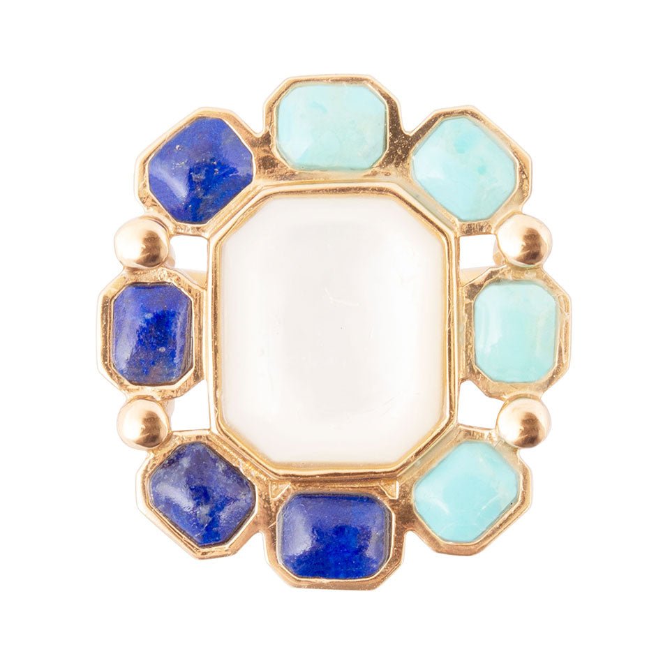 Ring with blue and green gemstones on a white background