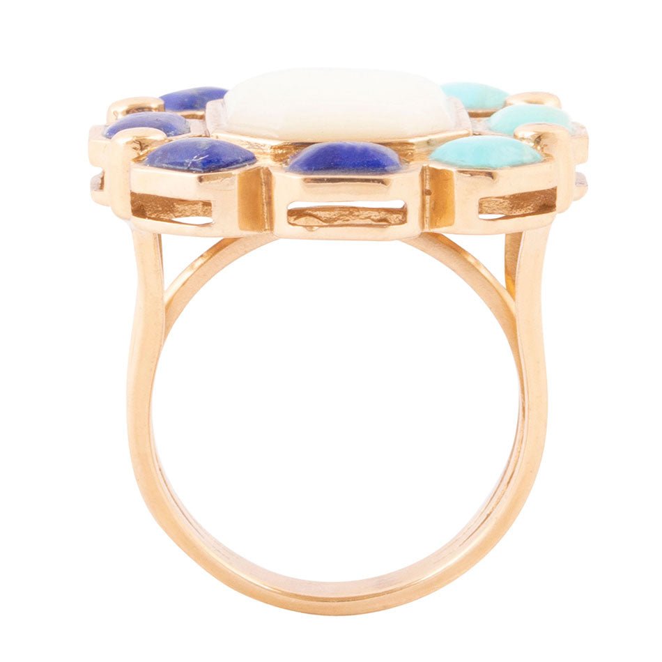 Gold ring with multicolored gemstones on a white background