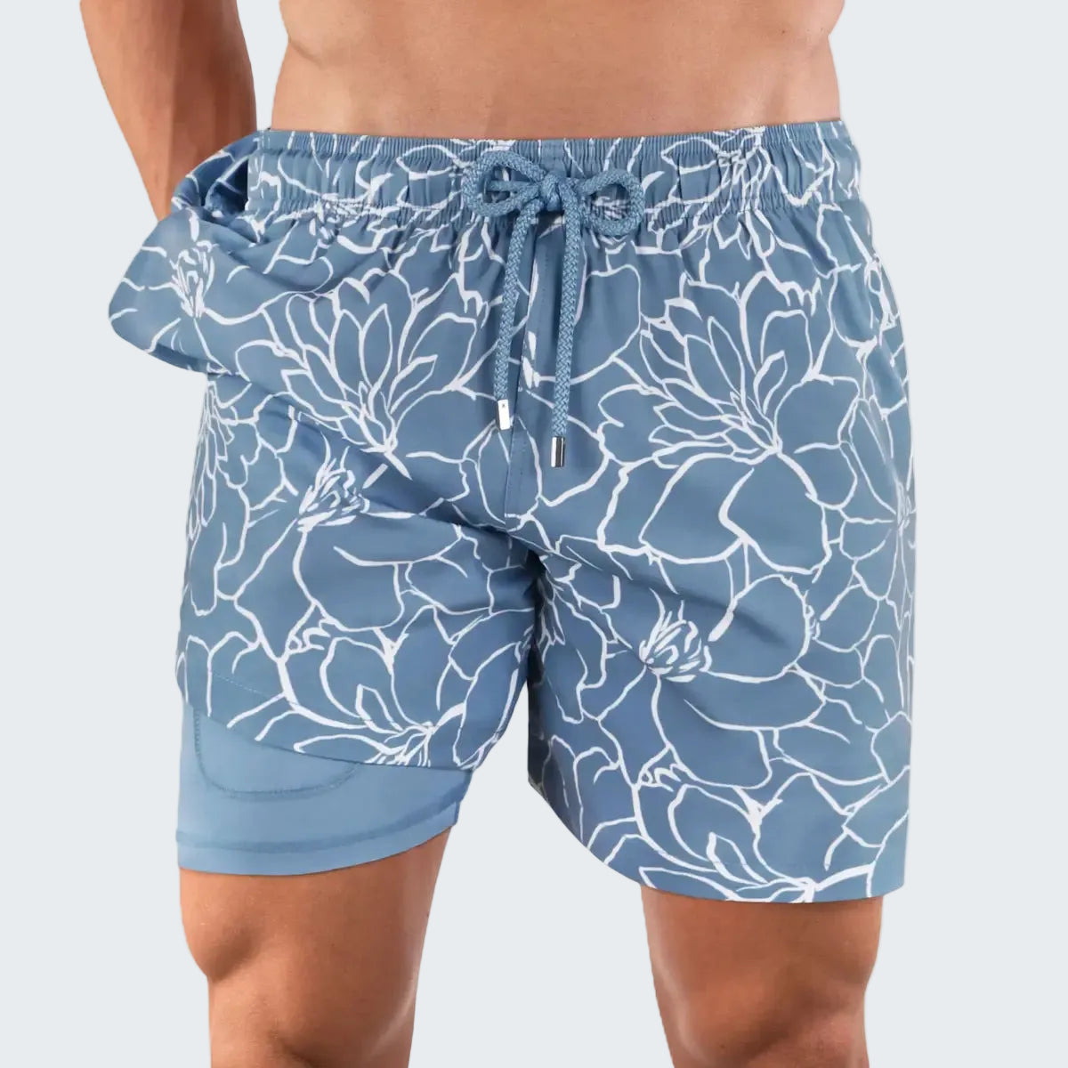 Blue floral-patterned swim shorts on a white background