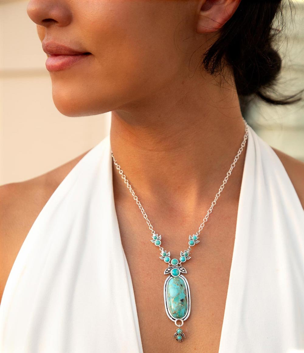 Woman wearing a turquoise necklace with a blurred background