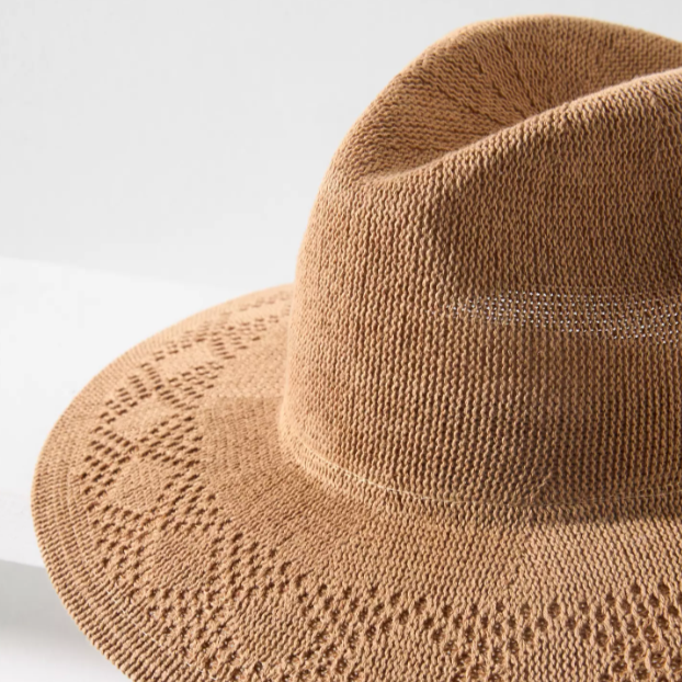 Brown knit hat on a light gray background