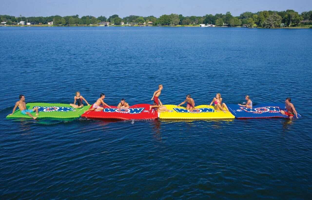 People on colorful inflatable rafts in a lake