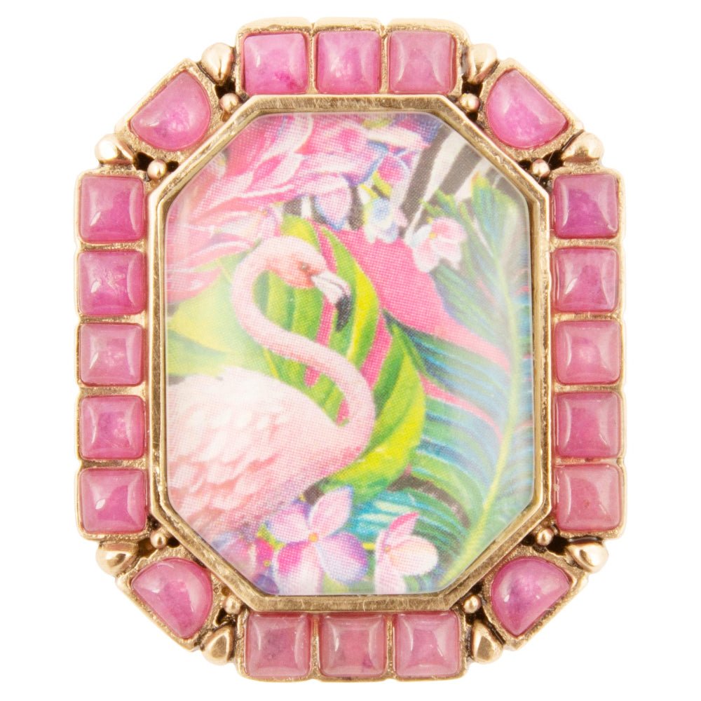 Decorative ring with pink flamingo design and gemstone accents on a white background