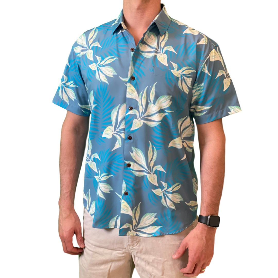 Man wearing a blue floral patterned shirt on a white background
