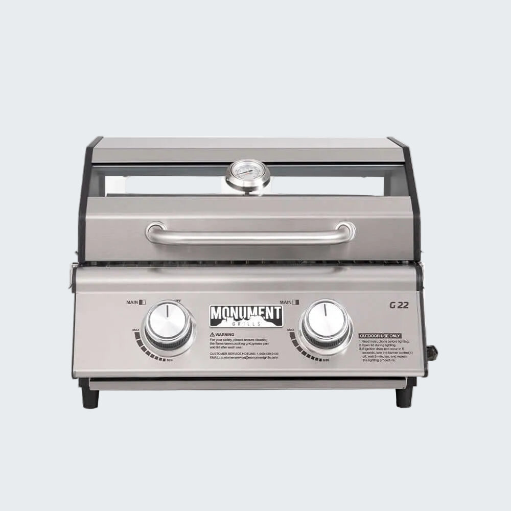 Stainless steel grill with 'Monument' branding on a white background