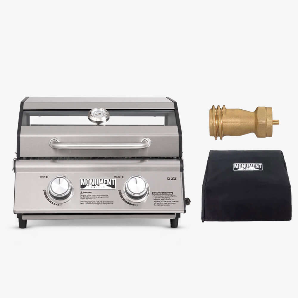 Grill with accessories including a brass fitting and black pouch on a white background