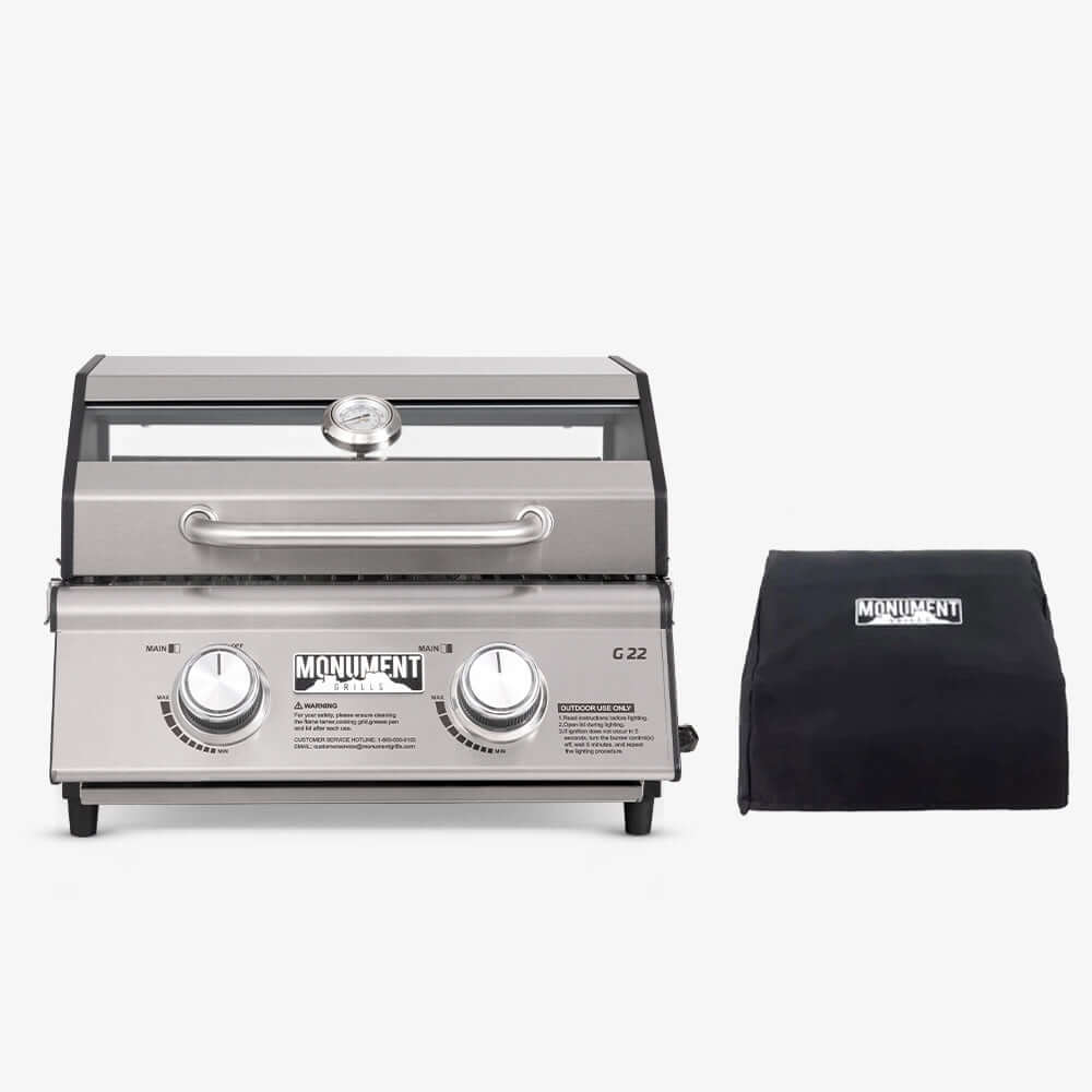 Stainless steel grill with black cover on a white background