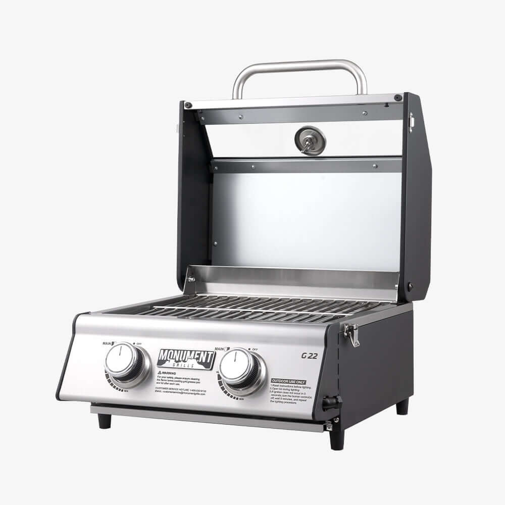 Stainless steel portable grill with visible brand name on a white background