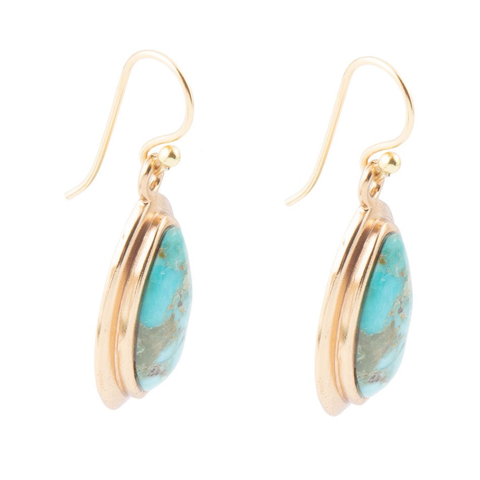Gold earrings with turquoise stones on a white background