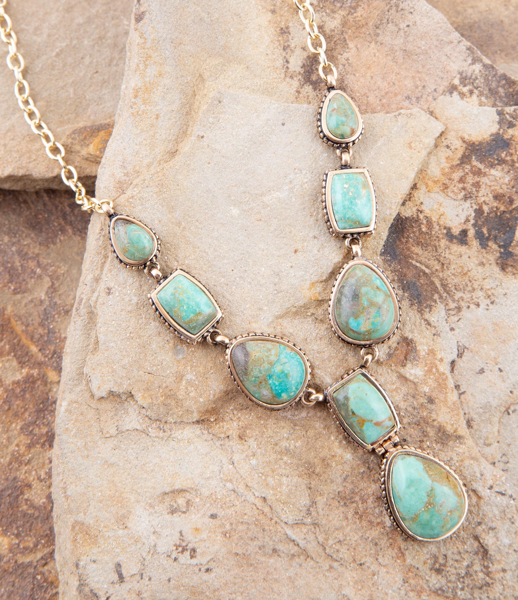 Turquoise stone necklace on a stone surface