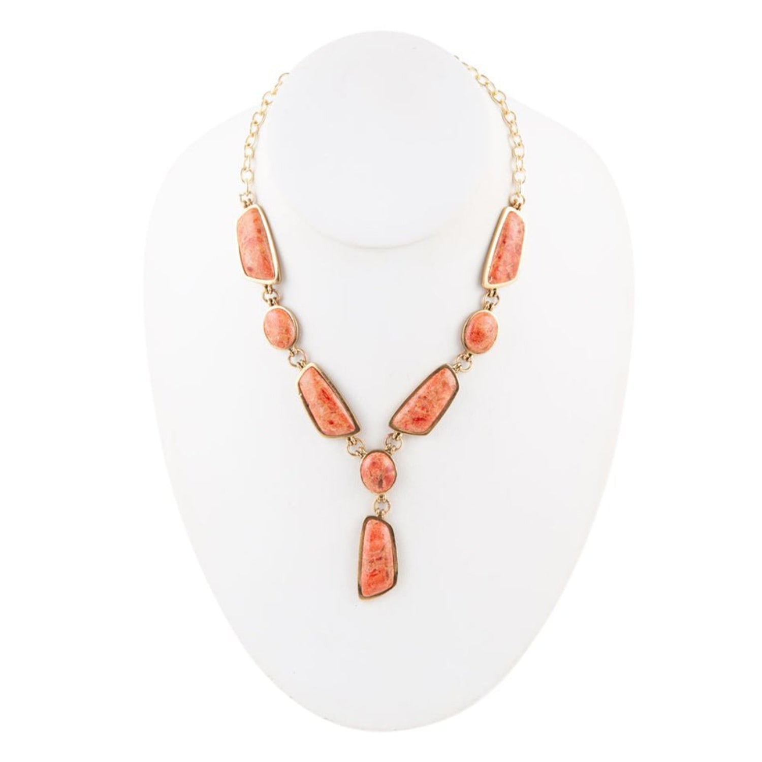 Necklace with pink beads on a white stand