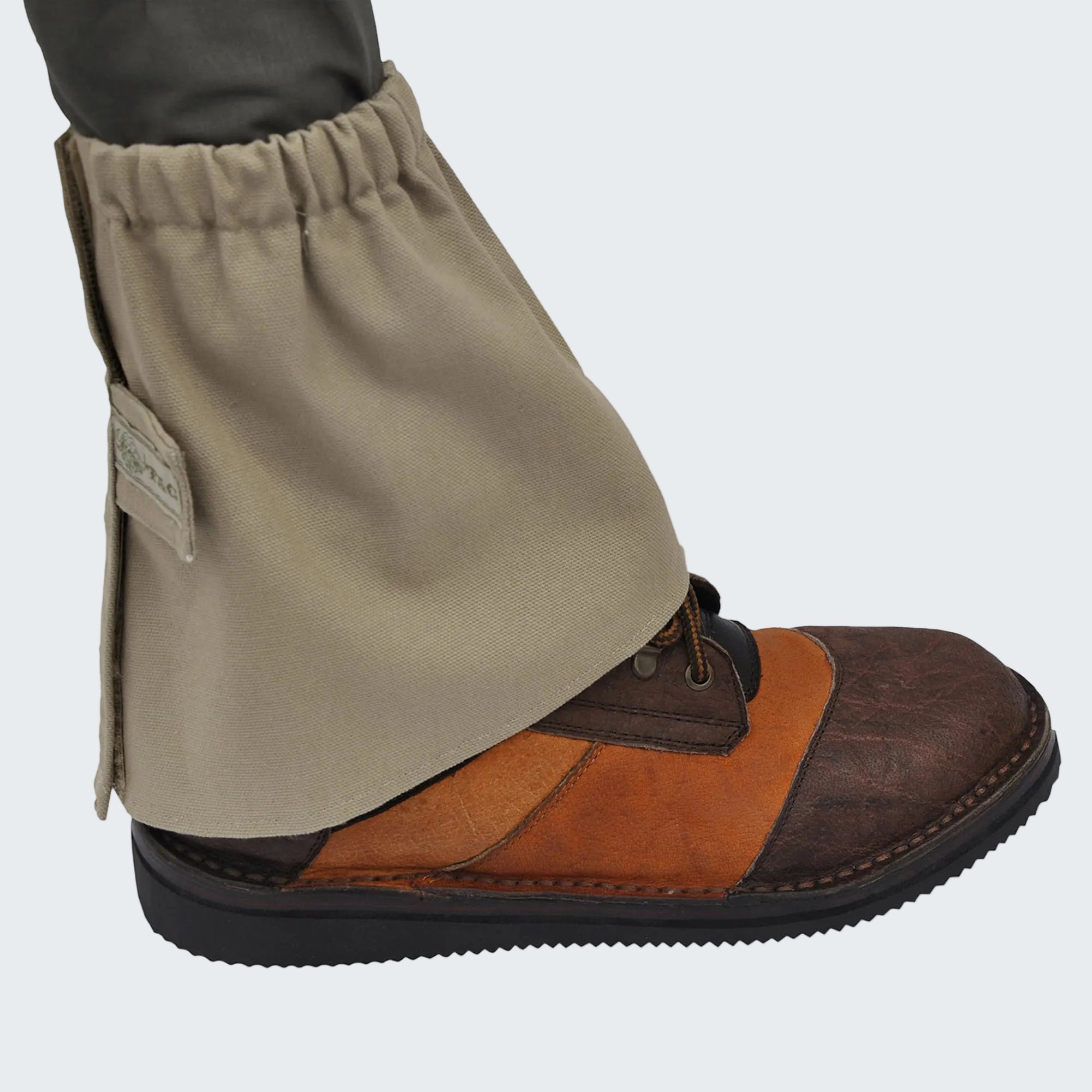 Brown leather boot with beige gaiter on a white background