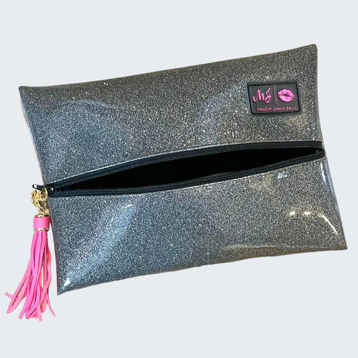 Glittery clutch bag with pink tassel and visible brand logo on a white background