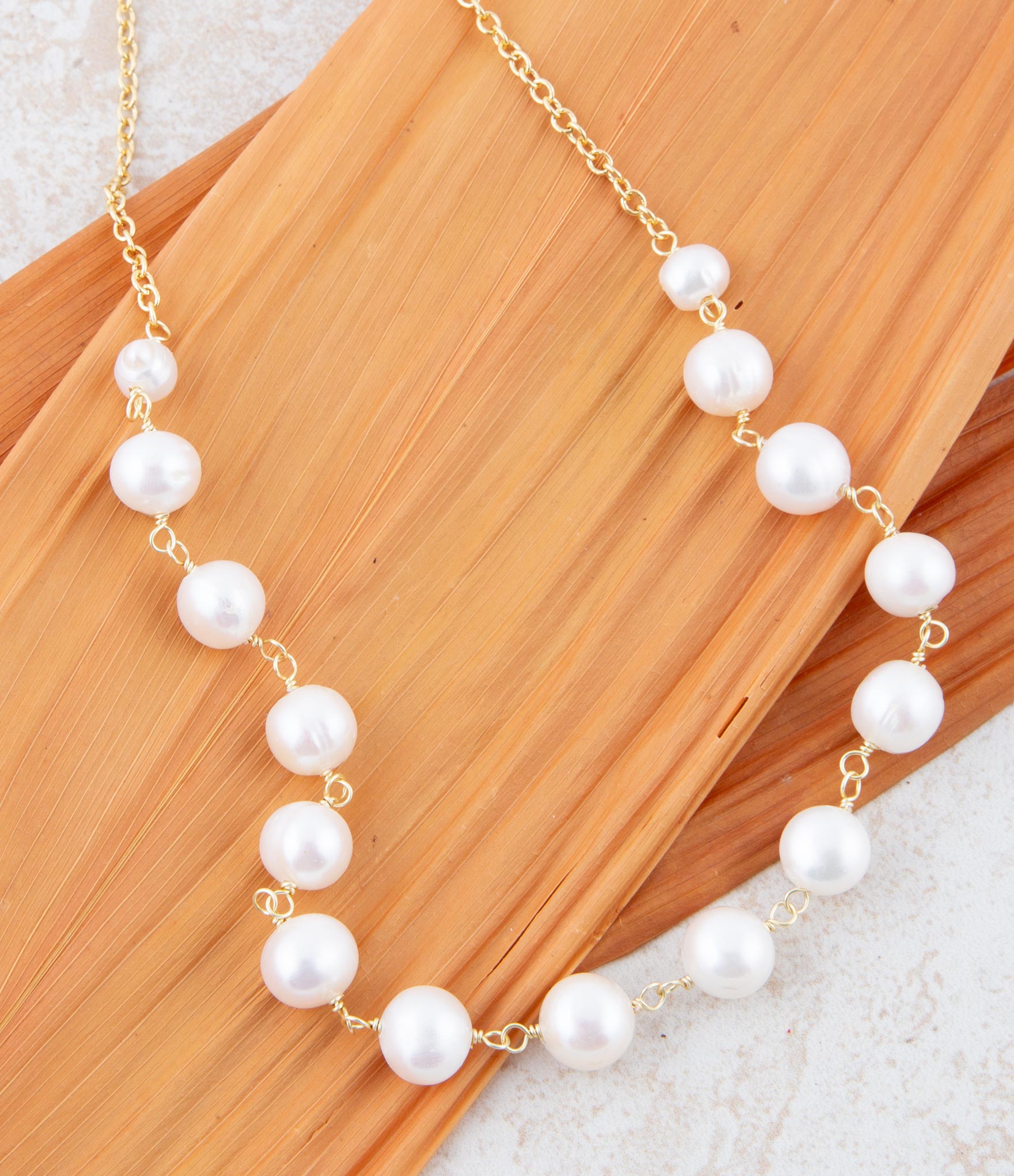 Pearl necklace on a wooden surface
