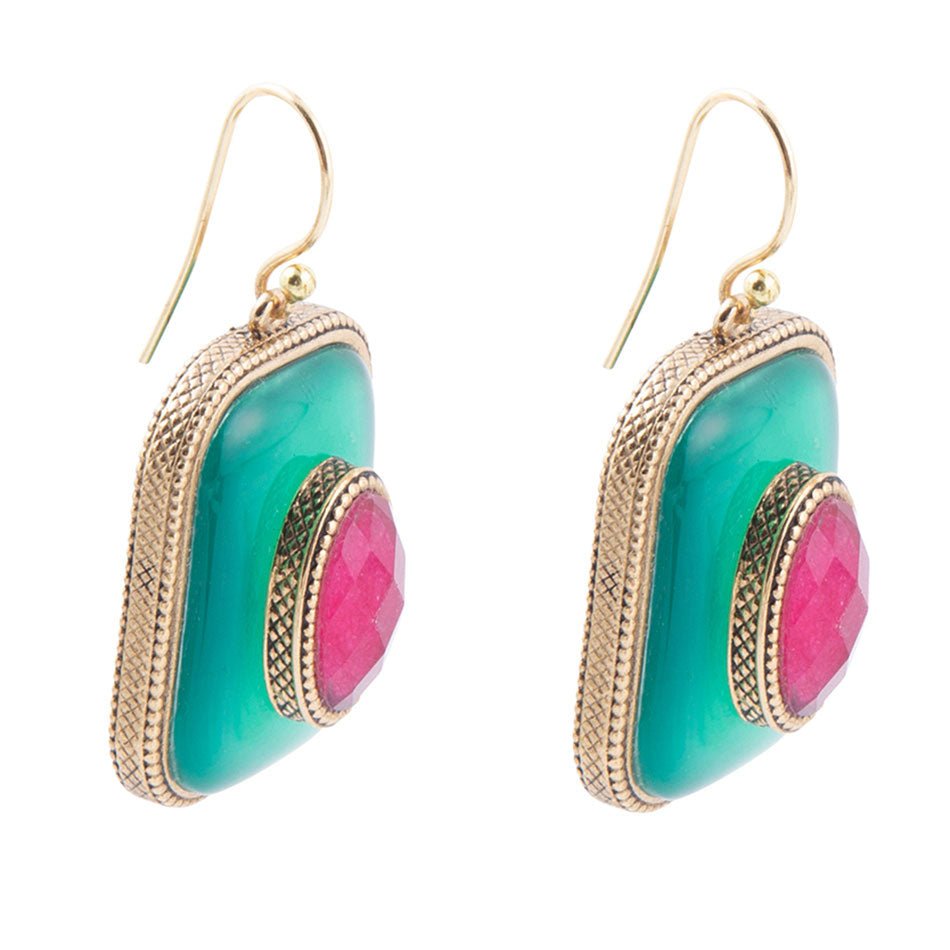 Pair of earrings with green and pink circular stones on a white background