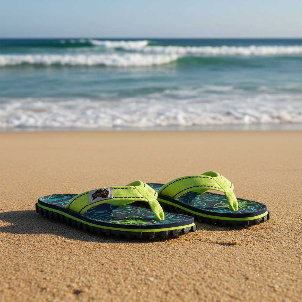 Pair of Gumbies flip-flops with floral pattern on a white background