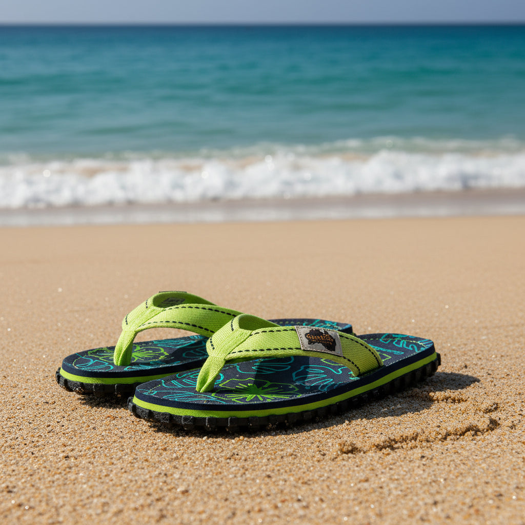 Pair of Gumbies flip-flops with floral pattern on a white background