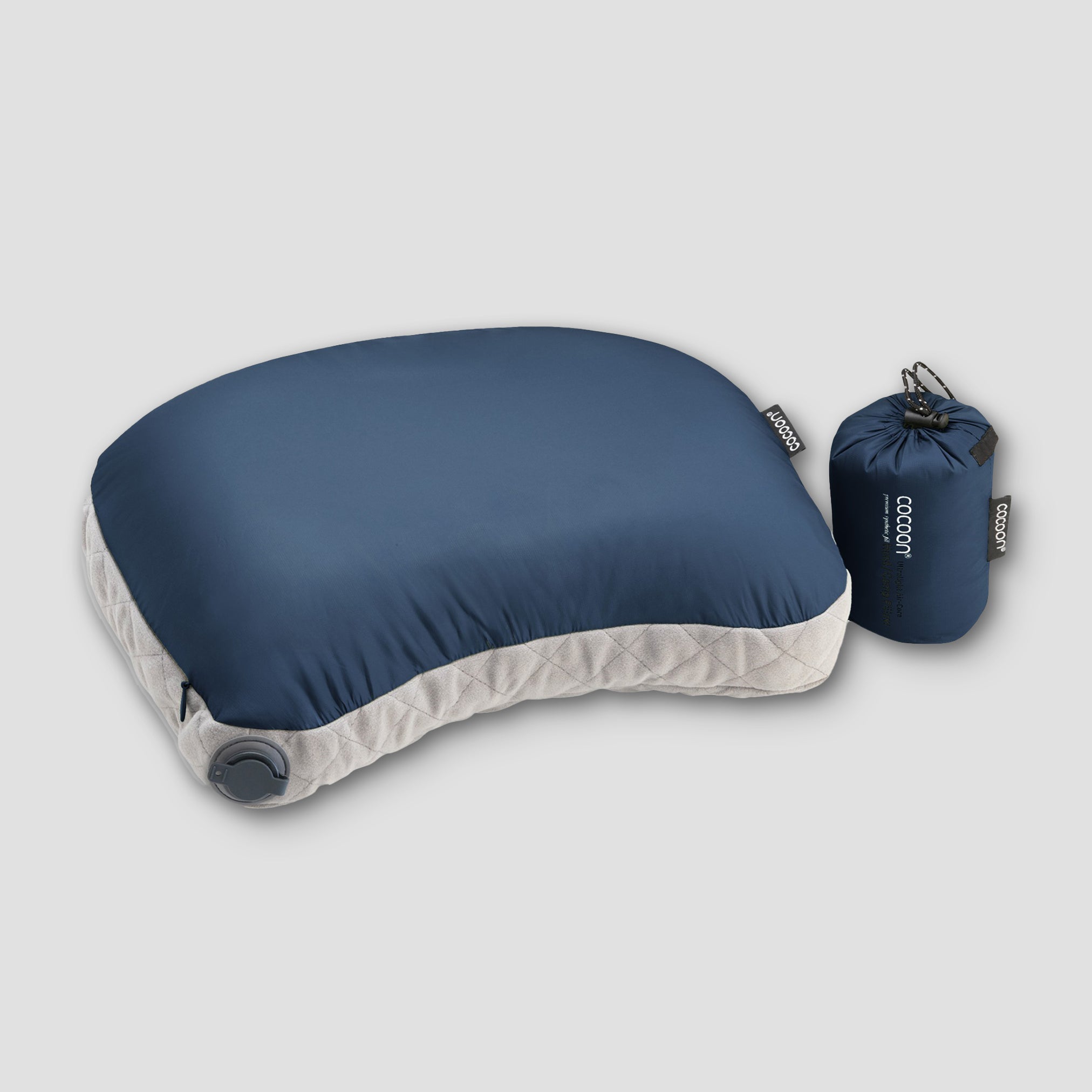 Blue travel pillow with a matching carrying case on a light gray background