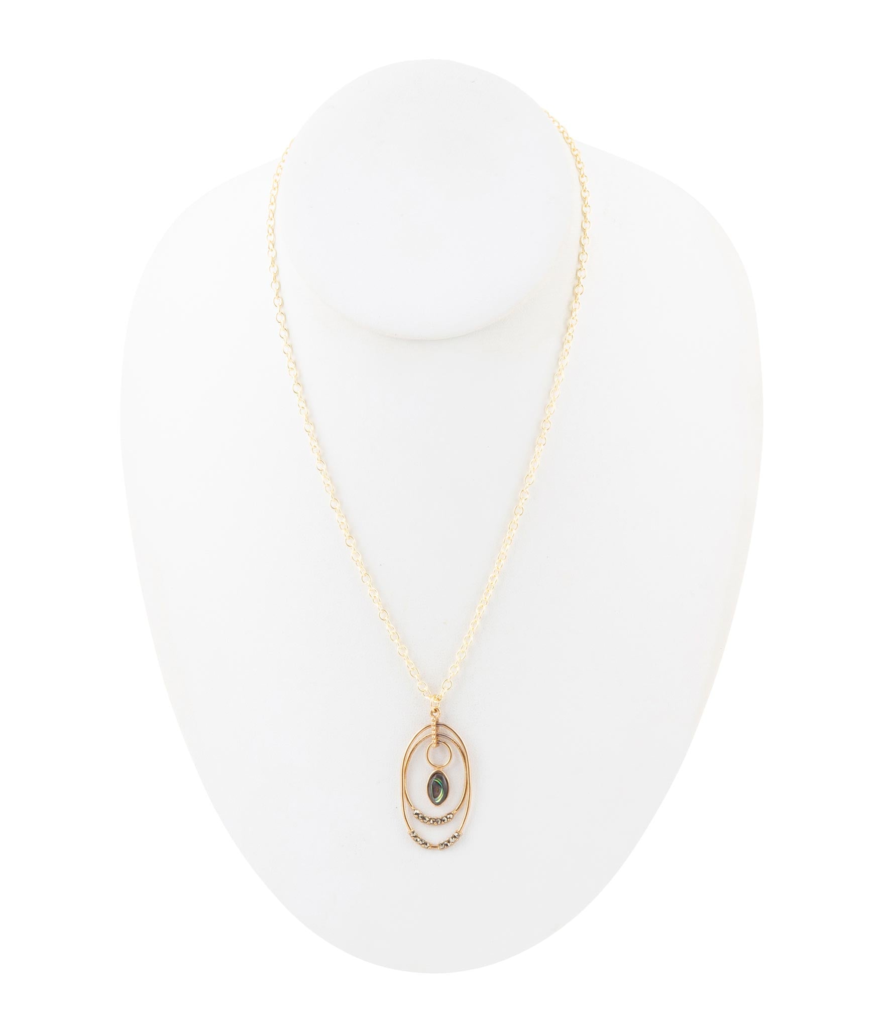 Gold necklace with a pendant on a white mannequin bust